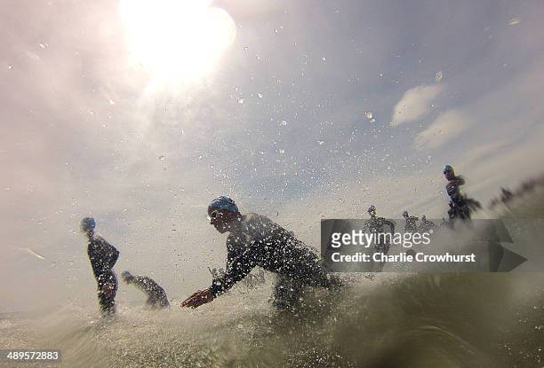 Participants enter the sea to begin the swim leg during the Challenge Triathlon Rimini on May 11, 2014 in Rimini, Italy.