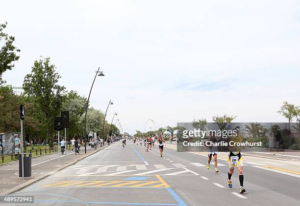 Participants run along the sea front during the run leg during the Challenge Triathlon Rimini on May 11, 2014 in Rimini, Italy.