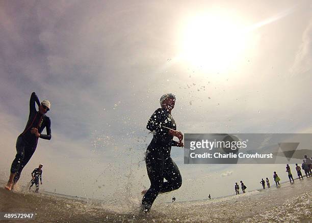 Participants exit the water after the swim leg during the Challenge Triathlon Rimini on May 11, 2014 in Rimini, Italy.