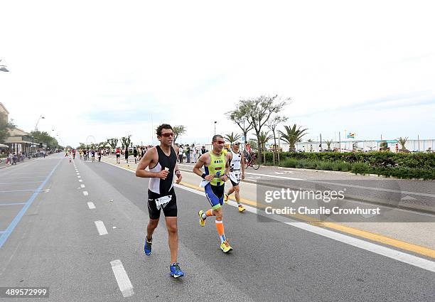 Participants run along the sea front during the run leg during the Challenge Triathlon Rimini on May 11, 2014 in Rimini, Italy.