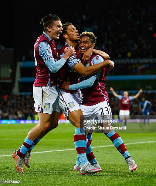 Rudy Gestede of Aston Villa celebrates scoring their first goal with Jack Grealish and Jordan Amavi of Aston Villa during the Capital One Cup third...