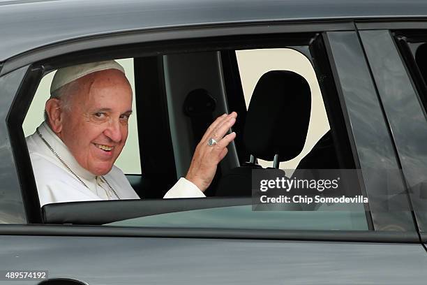 Pope Francis waves from the back of his Fiat after arriving from Cuba September 22, 2015 at Joint Base Andrews, Maryland. Francis will be visiting...