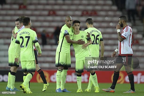 Manchester City's Brazilian midfielder Fernando and Manchester City's Spanish midfielder Manu Garcia embrace at the final whistle during the English...
