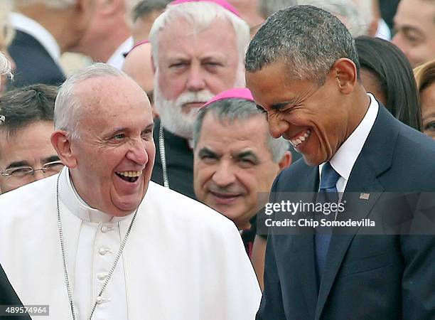 Pope Francis is escorted by U.S. President Barack Obama as he greets and other political and Catholic church leaders after arriving from Cuba...