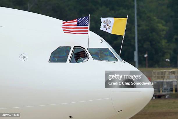 The papal flag and the U.S. Flag fly from the cockpit of Pope Francis' airplane after it arrived from Cuba September 22, 2015 at Joint Base Andrews,...