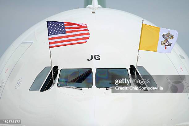 The papal flag and the U.S. Flag fly from the cockpit of Pope Francis' airplane after it arrived from Cuba September 22, 2015 at Joint Base Andrews,...