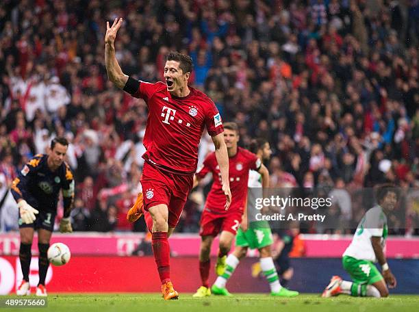 Robert Lewandowski of Bayern Munich celebrates scoring his 4th goal during the Bundesliga match between FC Bayern Muenchen and VfL Wolfsburg at...