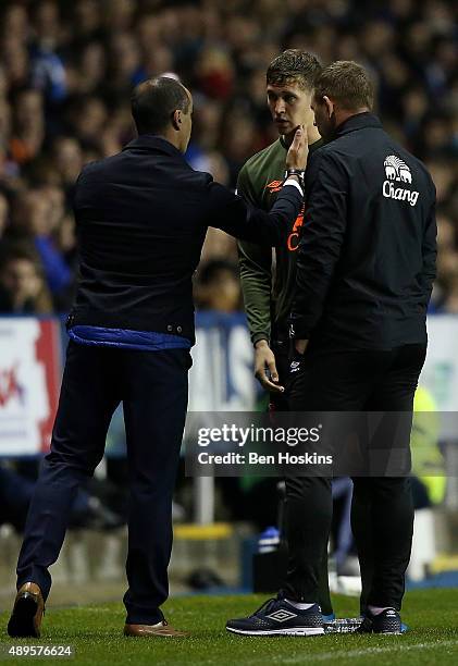 John Stones of Everton speaks with Everton manager Roberto Martinez after picking up an injury during the Capital One Cup Third Round match between...