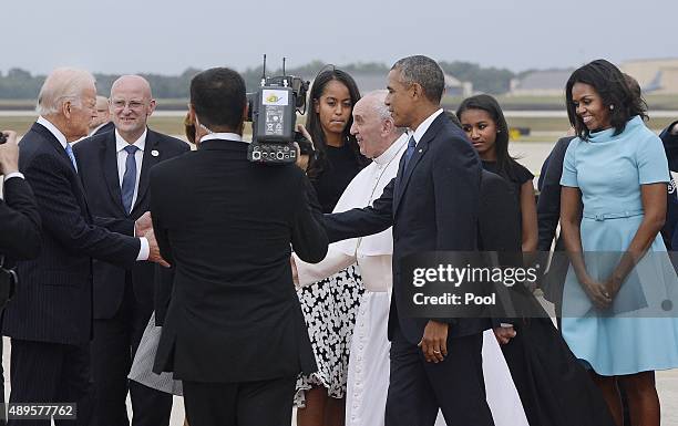 Pope Francis is greeted by U.S. President Barack Obama, first lady Michelle Obama, daughters Sasha and Malia, Vice President Joe Biden and invited...