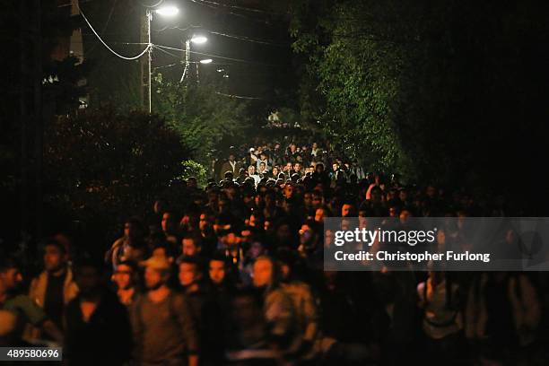 Migrants who arrived on the third train today, at Hegyeshalom on the Hungarian and Austrian border, walk the four kilometres into Austria on...