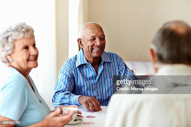 senior man having coffee with friends - septuagénaire photos et images de collection