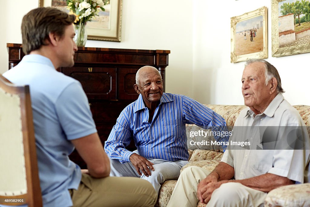 Caretaker spending leisure time with senior men