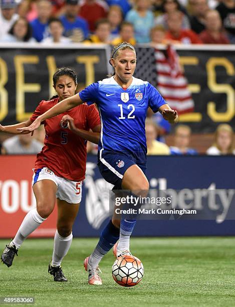 Lauren Holiday of the United States dribbles the ball ahead of Sabine Chandler of Haiti during the U.S. Women's 2015 World Cup Victory Tour at Ford...