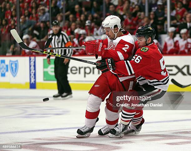 Marko Dano of the Chicago Blackhawks battles for the puck with Brendan Smith of the Detroit Red Wings during a preseason game at the United Center on...