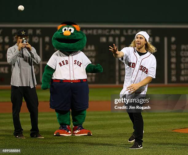 Olympic gold medalist Joss Christensen takes a picture of fellow Olympic gold medalist Sage Kotsenburg as he throws out the first pitch during a...