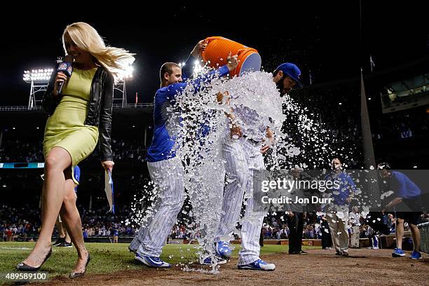 Jake Arrieta of the Chicago Cubs is doused after his 20th win of the season against the Milwaukee Brewers at Wrigley Field on September 22, 2015 in...