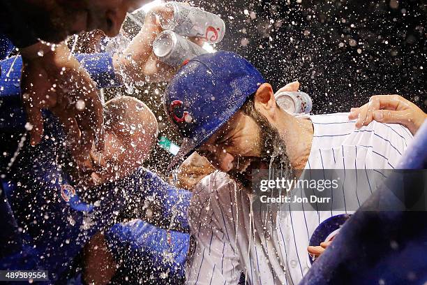 The Chicago Cubs celebrate with Jake Arrieta on his 20th win of the season against the Milwaukee Brewers at Wrigley Field on September 22, 2015 in...