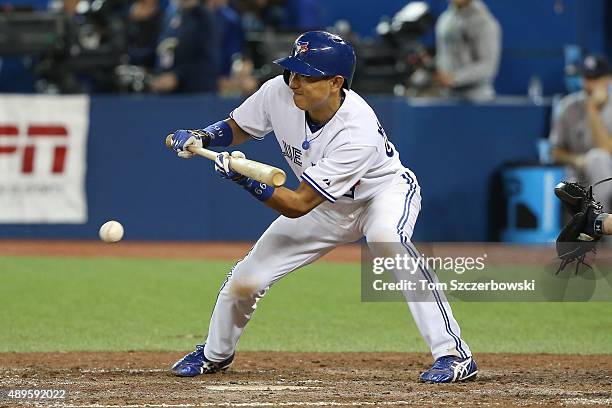 Munenori Kawasaki of the Toronto Blue Jays lays down a sacrifice bunt in the eighth inning during MLB game action against the New York Yankees on...