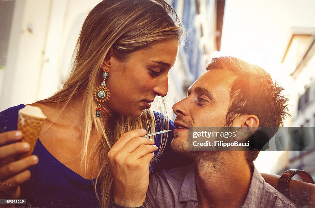 Young couple in love while eating an ice-cream