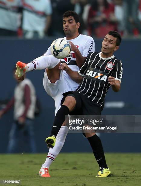 Maicon of Sao Paulo fights for the ball with Petros of Corinthians during the match between Sao Paulo and Corinthians for the Brazilian Series A 2014...