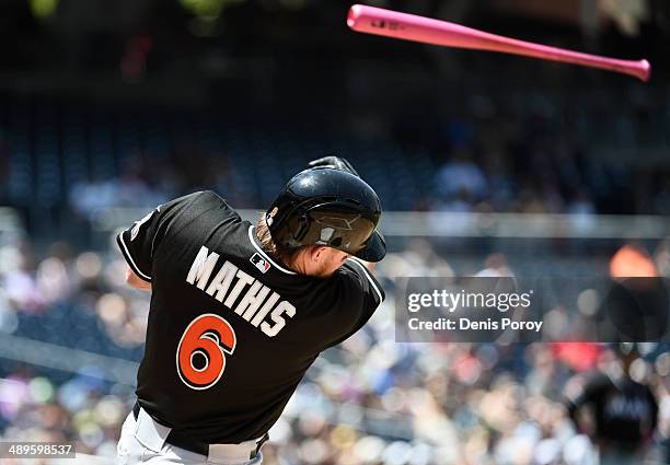Jeff Mathis of the Miami Marlins loses hit bat into the stands during the second inning of a baseball game against the San Diego Padres at Petco Park...