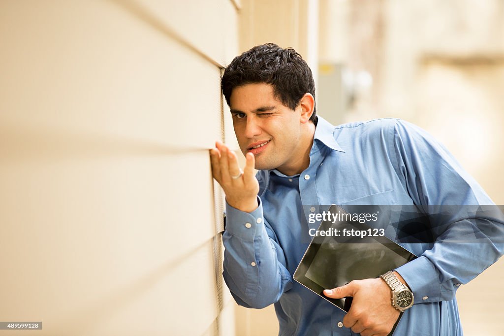 Inspector, engineer examines building wall, window outdoors. Digital tablet.