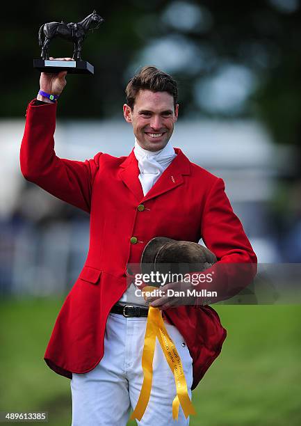 Harry Meade celebrates with the Cotswold Life Trophy on day five of the Badminton Horse Trials on May 11, 2014 in Badminton, England.
