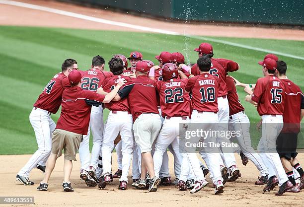 South Carolina Gamecocks celebrate around Joey Pankake after he drove in the winning run against the Missouri Tigers at the Carolina Stadium in...