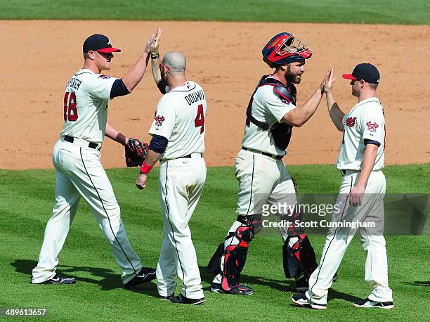 David Carpenter, Ryan Doumit, Evan Gattis, and Tyler Pastornicky of the Atlanta Braves celebrate after the game against the Chicago Cubs at Turner...