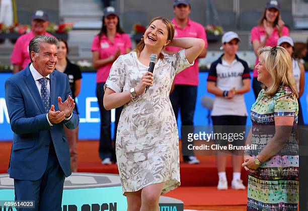Dinara Safina of Russia makes a speach to the crowd announcing her retirement watched by Stacey Allaster, CEO of the WTA Tour and Manolo Santana,...