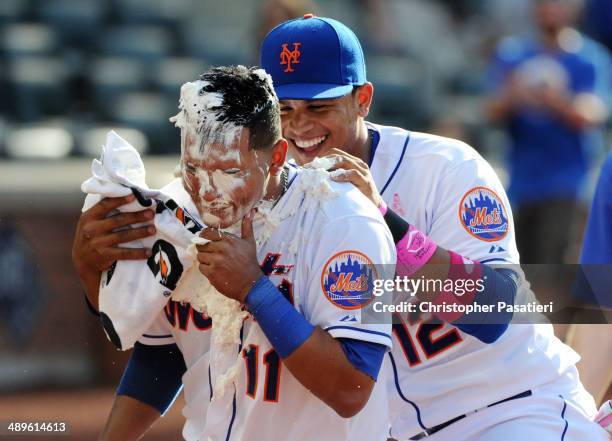 Ruben Tejada of the New York Mets is given a celebratory pie to the face by teammate Juan Lagares after hitting a game-winning walk-off single in the...