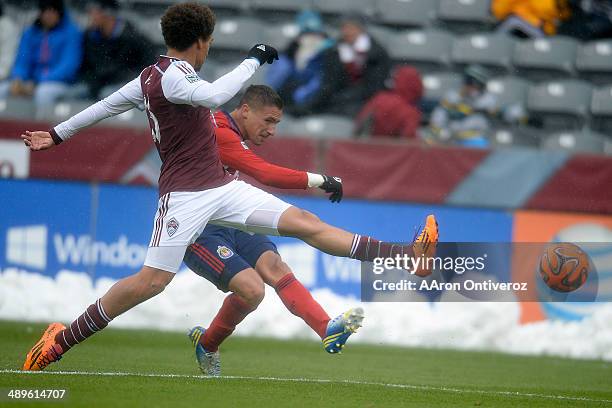 Leandro Barrera of Chivas USA kicks the ball past Chris Klute of Colorado Rapids during the second half. Chivas USA defeated the Colorado Rapids 3-1...