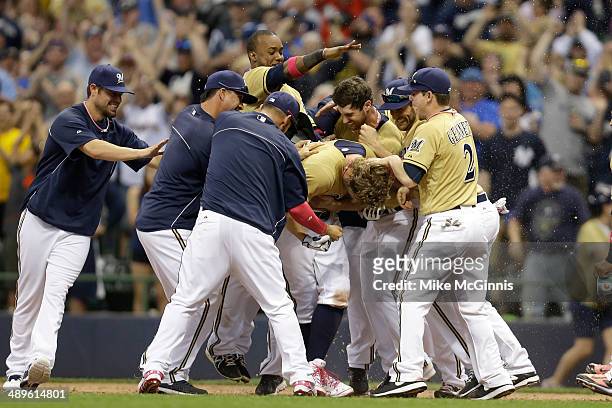 Mark Reynolds of the Milwaukee Brewers celebrates with his team after hitting a walk off single in the bottom of the ninth inning against the New...