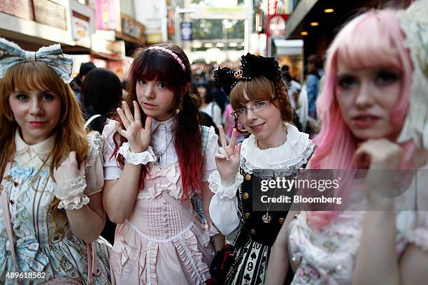 Tourists dressed in cosplay outfits pose for a photograph on Takeshita Street in the Harajuku area of Tokyo, Japan, on Tuesday, Sept. 22, 2015. The...