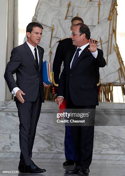 French President Francois Hollande talks with French Prime Minister Manuel Valls after the Cabinet Meeting at the Elysee Palace on September 23, 2015...