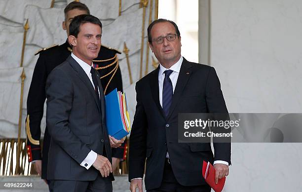 French President Francois Hollande talks with French Prime Minister Manuel Valls after the Cabinet Meeting at the Elysee Palace on September 23, 2015...