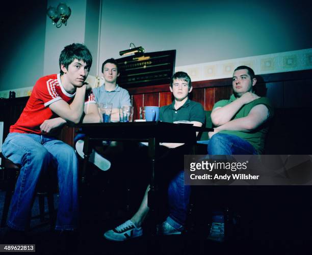 English indie rock band Arctic Monkeys in a pub, 2006. Left to right: singer Alex Turner, drummer Matt Helders, guitarist Jamie Cook and bassist Andy...