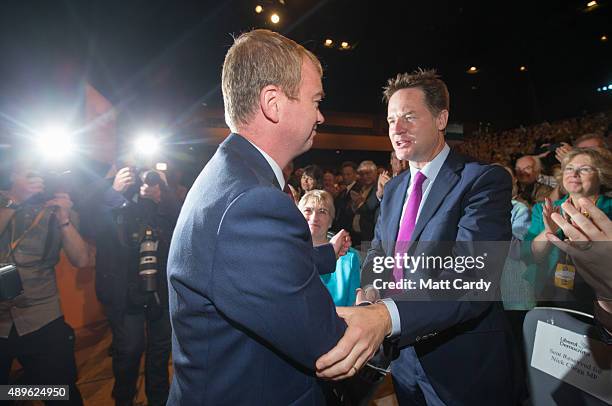 Liberal Democrat leader Tim Farron is congratulated by Nick Clegg as he leaves the main hall following his leader's speech on the final day of the...