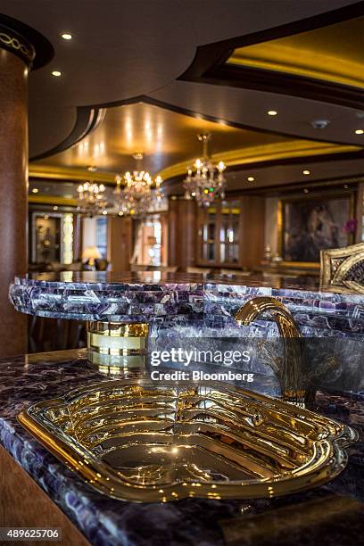 Gold taps and a sink sit in the bar area aboard luxury superyacht Solandge, built by Lurssen Werft GmbH & Co. KG, during the Monaco Yacht Show in...