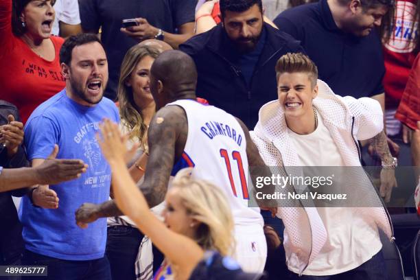 Scooter Braun and Justin Bieber congratulate Los Angeles Clipper Jamal Crawford at an NBA playoff game between the Oklahoma City Thunder and the Los...