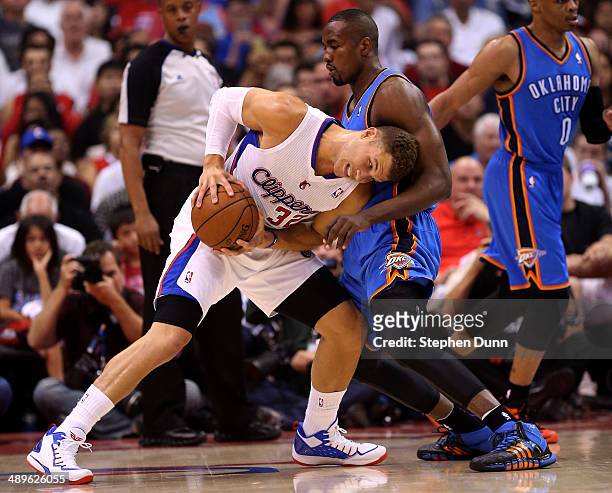 Blake Griffin of the Los Angeles Clippers battles Serge Ibaka of the Oklahoma City Thunder in Game Four of the Western Conference Semifinals during...