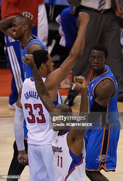 Danny Granger and Jamal Crawford of the Los Angeles Clippers celebrate their 101- 99 victory before members of the Oklahoma City Thunder in Game 4 of...