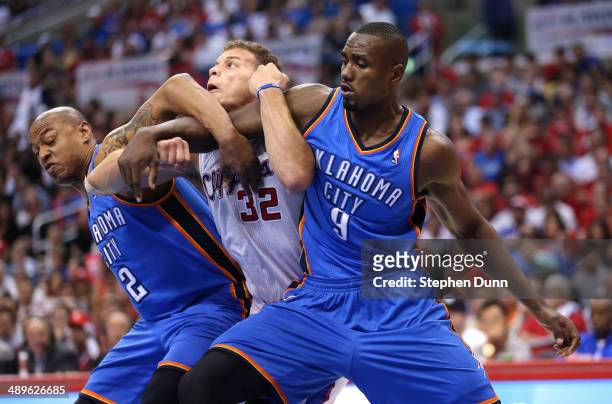 Blake Griffin of the Los Angeles Clippers battles for postion under the boards with Serge Ibaka and Caron Butler of the Oklahoma City Thunder in Game...