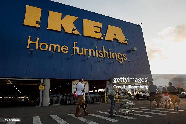 People walk in the parking lot of an Ikea store in the Brooklyn borough of New York, U.S., on Saturday, Sept. 19, 2015. The U.S. Census Bureau is...