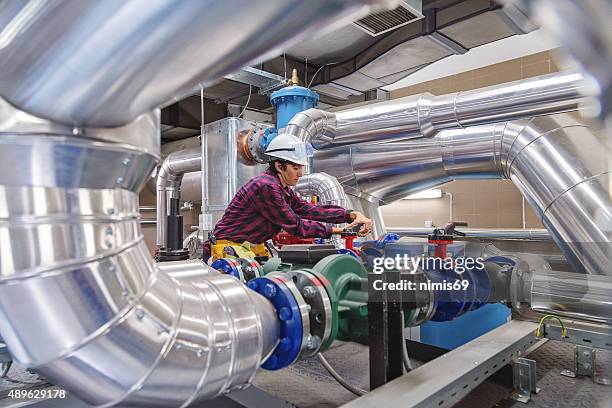 technician working on valve in factory or utility - machine valve stock pictures, royalty-free photos & images
