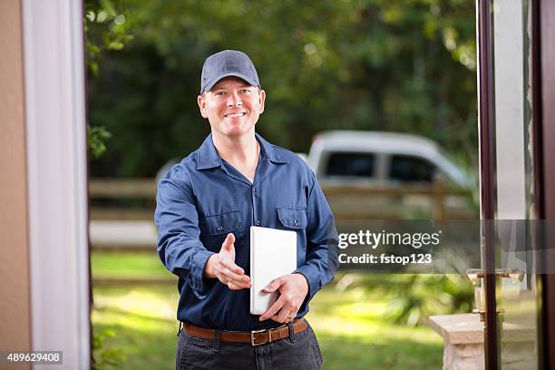 service industry: repairman at customer's front door. digital tablet. handshake. - visit stock pictures, royalty-free photos & images