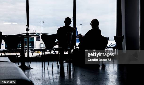 couple waiting in airport departure terminal - relfection stock pictures, royalty-free photos & images