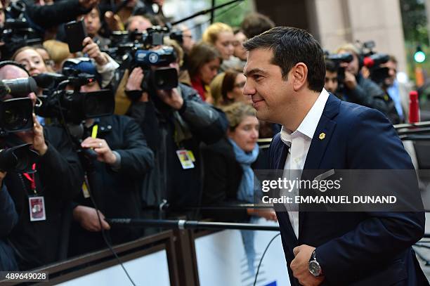 Greece's Prime minister Alexis Tsipras walks past journalists as he arrives to attend an European Union emergency summit on the migration crisis with...