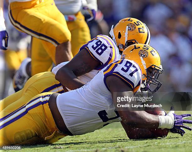 Frank Herron of the Louisiana State University Tigers causes and recovers a fumble against Jeremy Johnson of the Auburn University Tigers at Tiger...