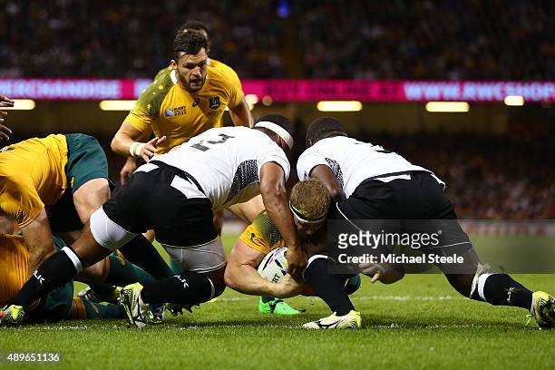 David Pocock of Australia goes over to score the opening try during the 2015 Rugby World Cup Pool A match between Australia and Fiji at the...
